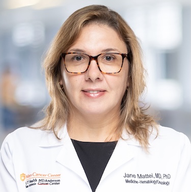 Dr. Jane Mattei in a white coat, smiling for a photo.